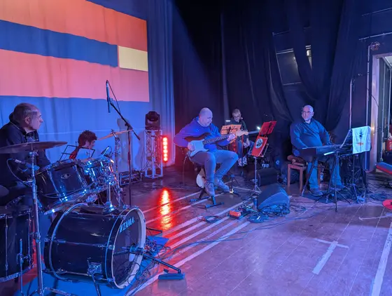 La band sul palco illuminata di rosso
